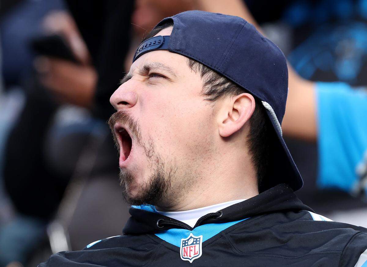 A Carolina Panthers fan follows the instructions to get loud as the Tampa Bay Buccaneers face third and long during action on Sunday, December 21, 2025 at Bank of America Stadium in Charlotte, NC. The Panthers defeated the Buccaneers 23-20. 