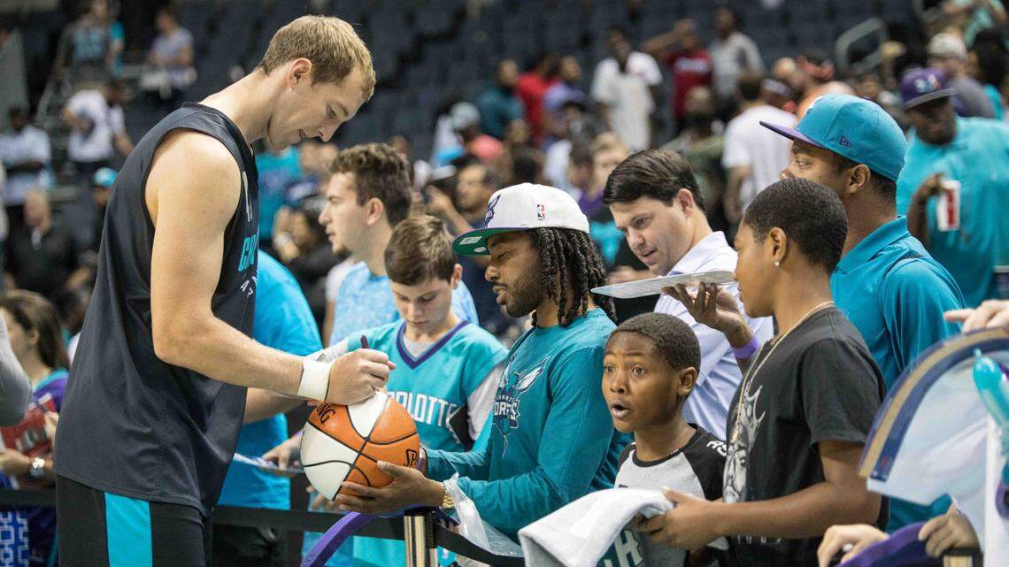Charlotte Hornets Cody Zeller is pictured signing autographs for fans in 2017. The Hornets have not had fans at games at Spectrum Center this season but that could soon change.