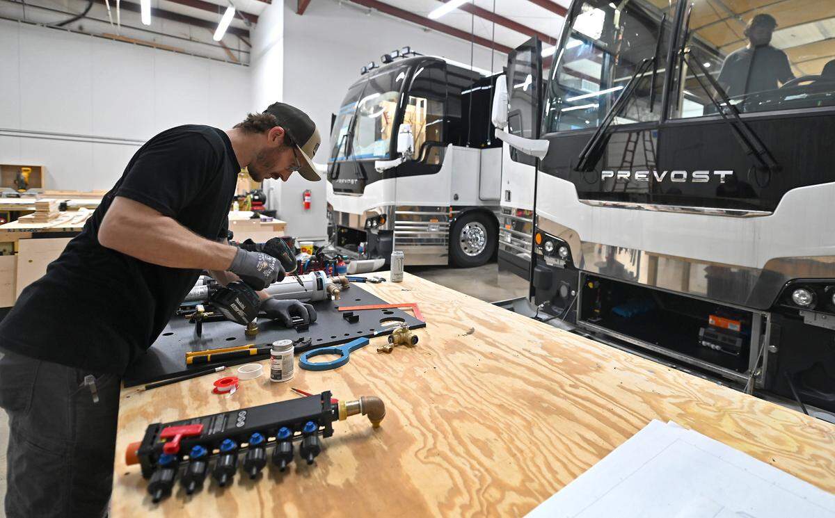 Kyle Egle builds the fresh water skid for an Encore Luxury Coach at the company’s bus factory in Cornelius on Tuesday.