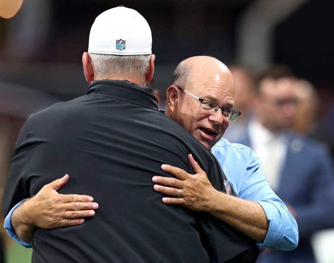 Carolina Panthers head coach Frank Reich, left, gets a big hug from team owner David Tepper, right, prior to the team’s game against the Atlanta Falcons at Mercedes-Benz Stadium in Atlanta, GA on Sunday, September 10, 2023. Reich lasted 11 games as head coach before Tepper fired him.