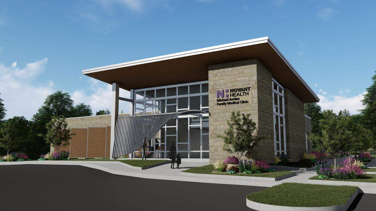 A rendering of the Novant Health Michael Jordan Family Clinic has a stone exterior with large windows around the entrance.  The patient rooms will also have windows to let in natural light, but wooden panels will protect privacy. The clinic will have 12 patient rooms and was designed by Charlotte architecture firm Neighboring Concepts.