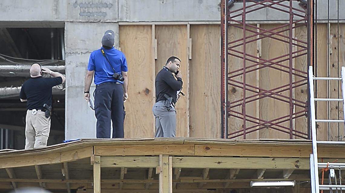 Investigators observe the scene of a death in a fall at an uptown Charlotte office building under construction,  part of the Legacy Union development, on the former Charlotte Observer site on Wednesday, May 23, 2018.