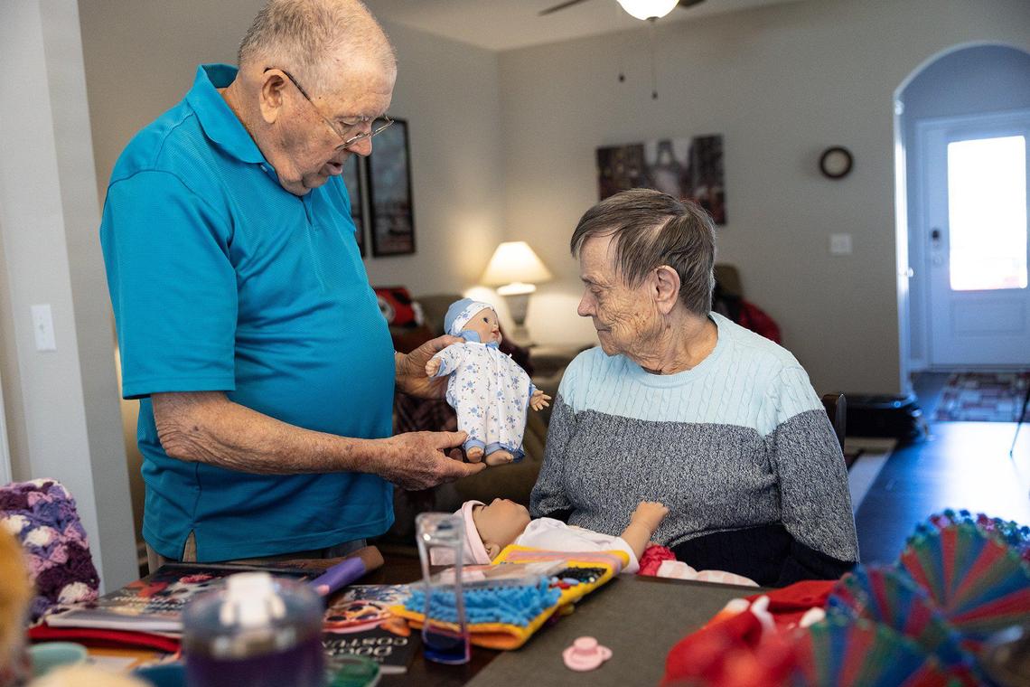 Bob Pettit, left, shows his wife, Betty, a doll that a fan sent to her.