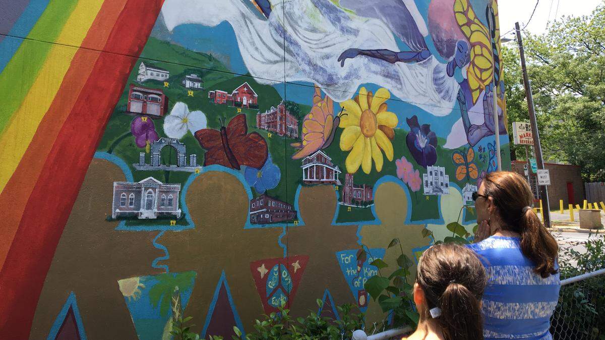 Shown on this Charlotte City Walk is the Biddleville history mural by a group of artists, co-led by Jamil Steele, who is the art teacher at Shamrock Elementary. The mural is on Beatties Ford Road in Historic West End.