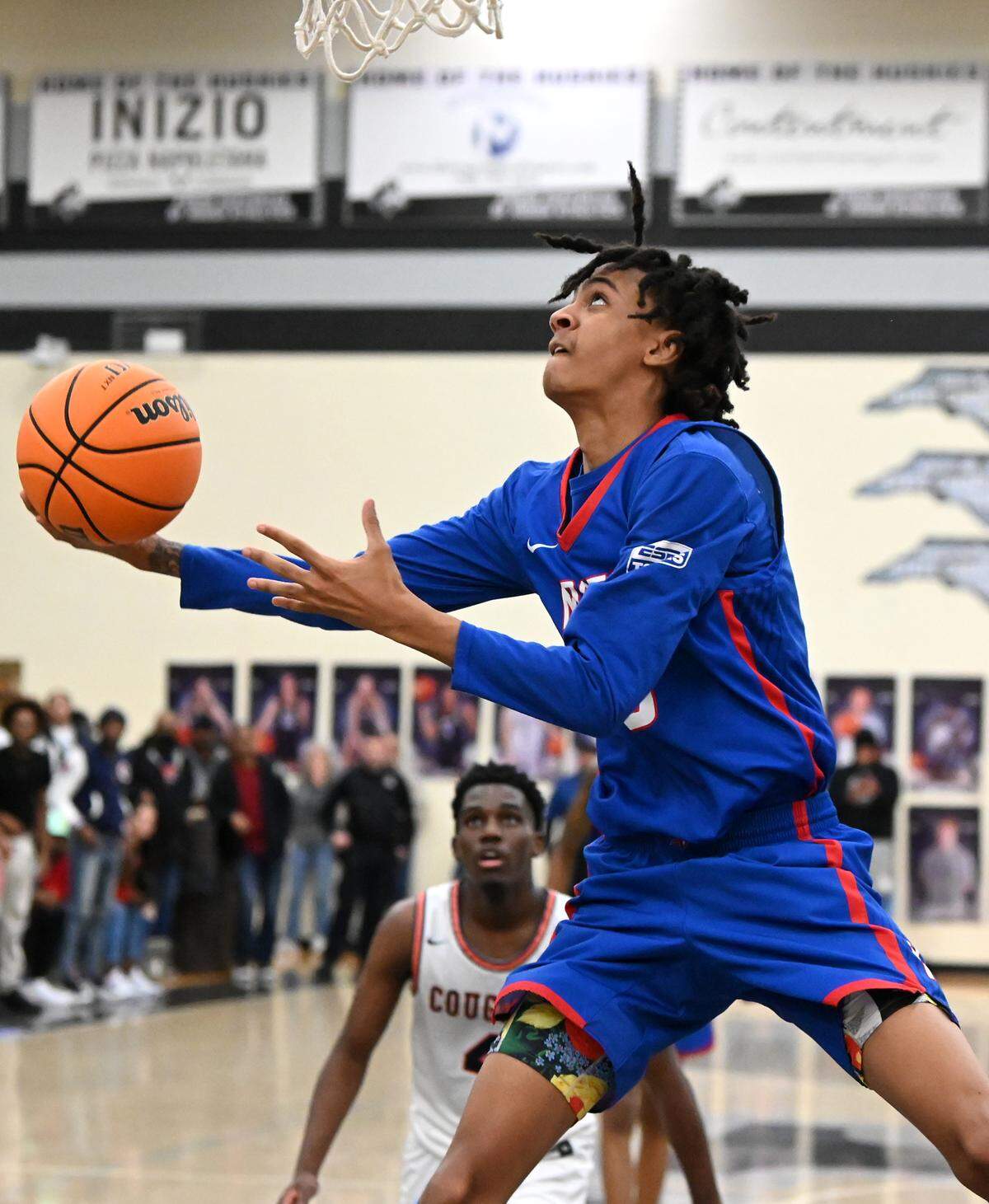 North Meck’s Trey Maxwell drives under the basket for two-points during second half action against Chambers on Friday, February 17, 2023. North Meck defeated Chambers to win the Queen City boys conference championship at Hough High School in Huntersville, NC.