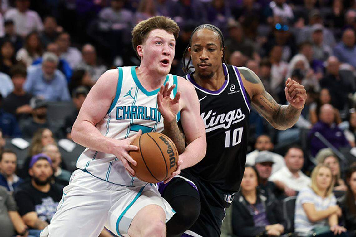 Kon Knueppel of the Charlotte Hornets is fouled by DeMar DeRozan of the Sacramento Kings during the first half at Golden 1 Center.