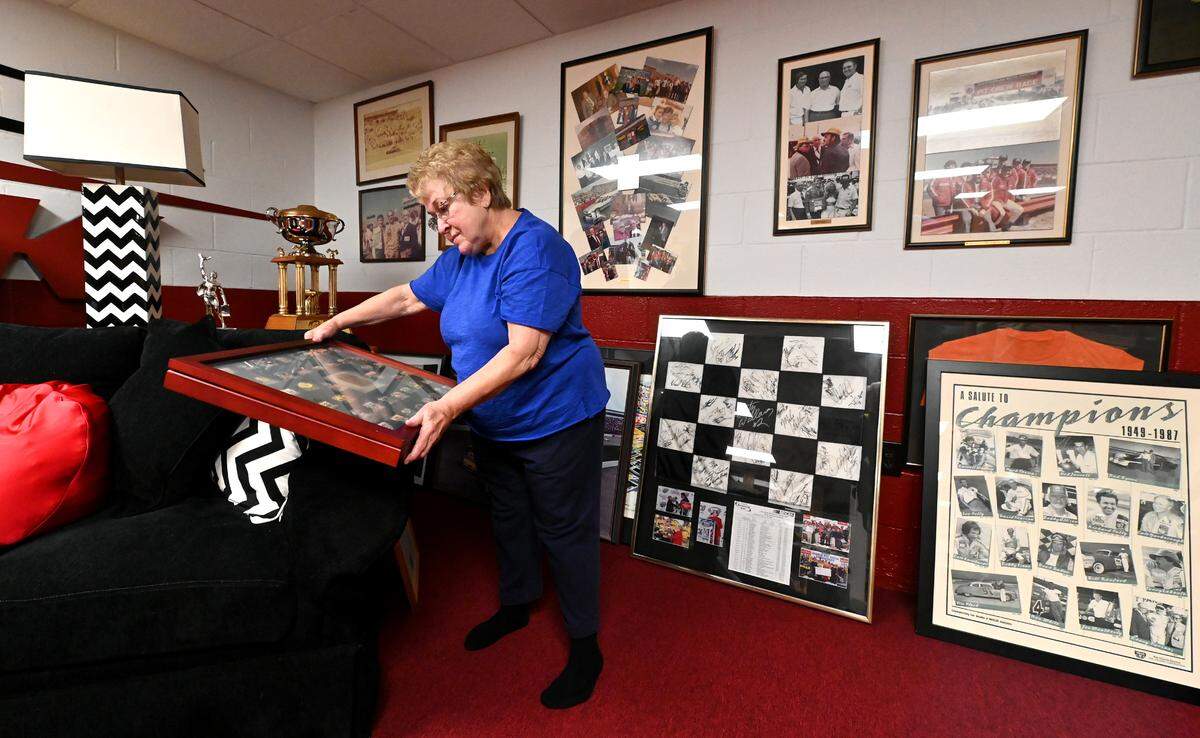 Nancy Daughtry, the daughter of former NASCAR Winston Cup Series stock car owner and President of North Carolina Motor Speedway L.G. DeWitt looks over race memorabilia at her home on Friday, April 18, 2025.. North Carolina Motor Speedway is known today as Rockingham Speedway aka. The Rock.