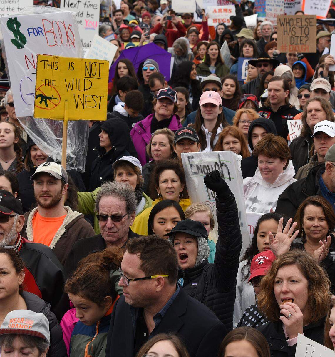 People with signs at First Ward Park during Saturday’s March For Our Lives rally in Charlotte, a student-led rally against gun violence.