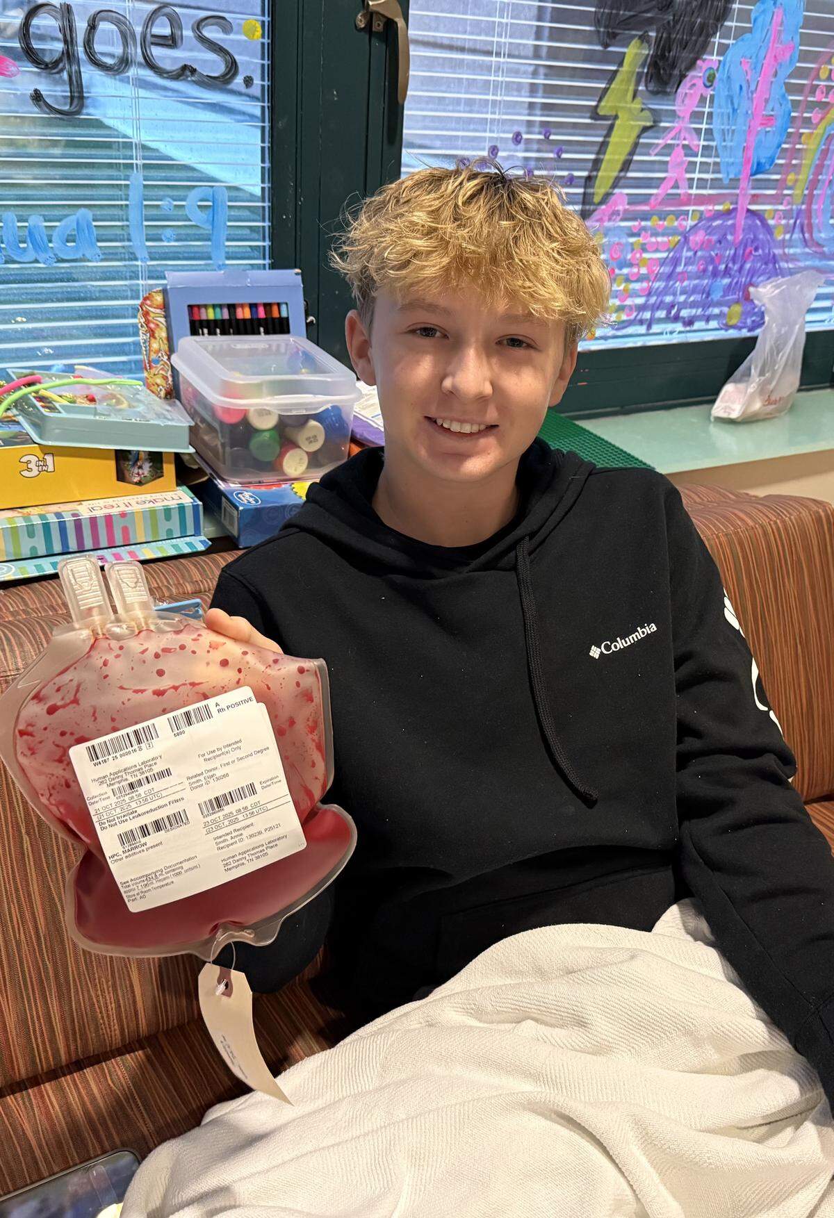 Eli Smith, then 14, holds a bag containing his stem cells before donating bone marrow to help save his younger sister Annie. As their father told him: “Your blood is the medicine.”