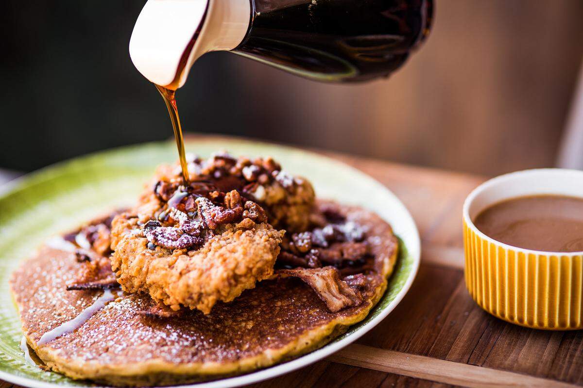 Tupelo Honey's Shoo Mercy sweet potato pancakes are topped with buttermilk fried chicken and hot honey. It is taking part in Triangle Restaurant Week.