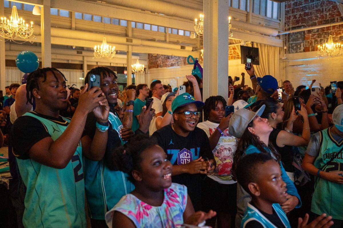 Charlotte Hornets fans react to the selection of Kon Knueppel in the first round of Wednesday’s NBA Draft at The Casey by Beau Monde, site of the team’s draft party.