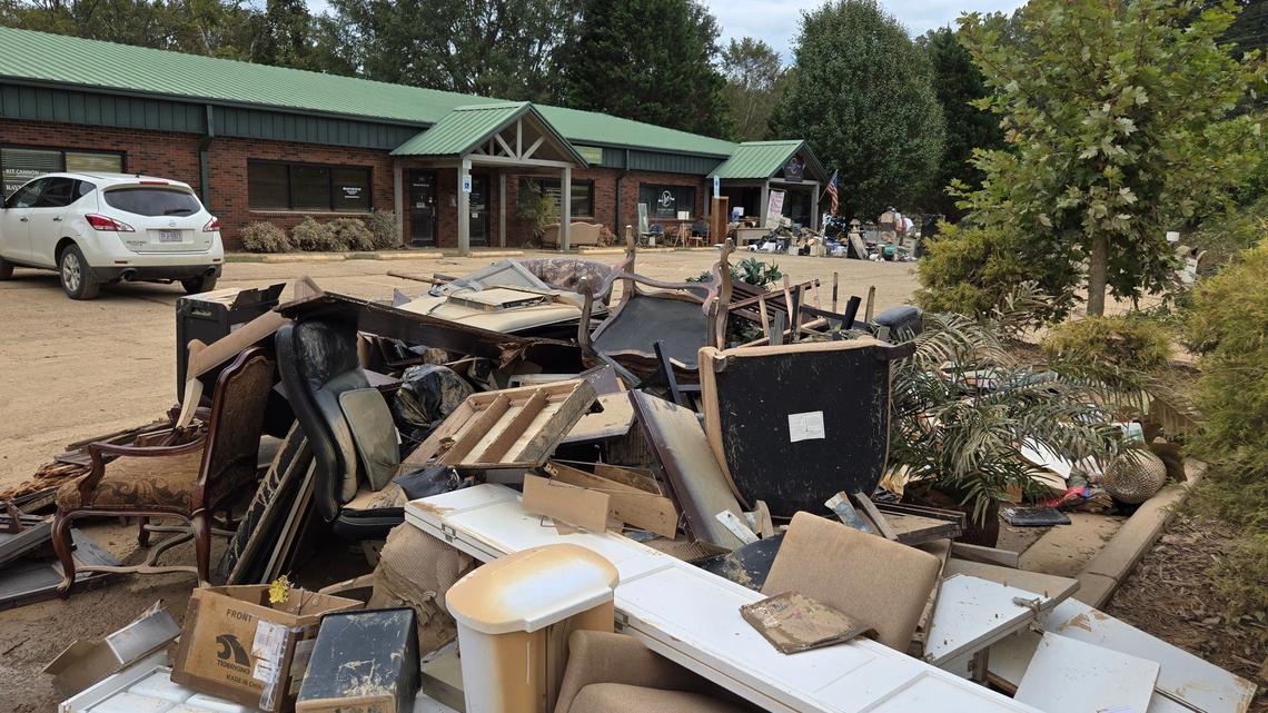 Flood-damaged furniture and office equipment were placed in a piles by business owners at the Rivers Village center in Morganton.
