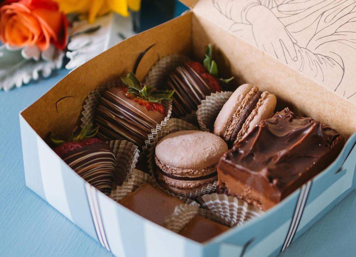 The Ultimate Chocolate Box at Amélie’s French Bakery and Café includes Chocolate Dipped Strawberries, Chocolate French Macarons, Salted Caramel Brownie halves and a Chocolate Layered Torte.