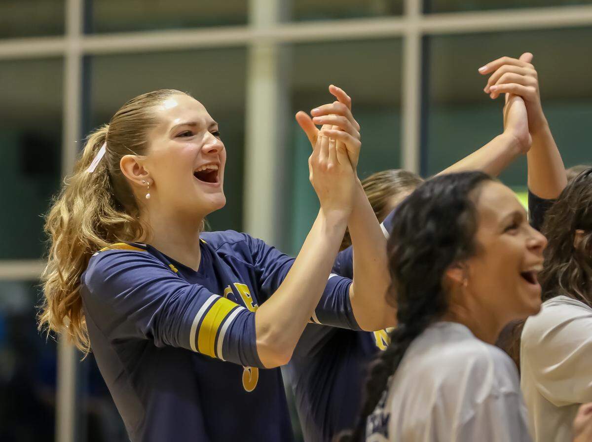North Raleigh Christian volleyball players celebrate during Saturday’s state championship win over Charlotte Latin.