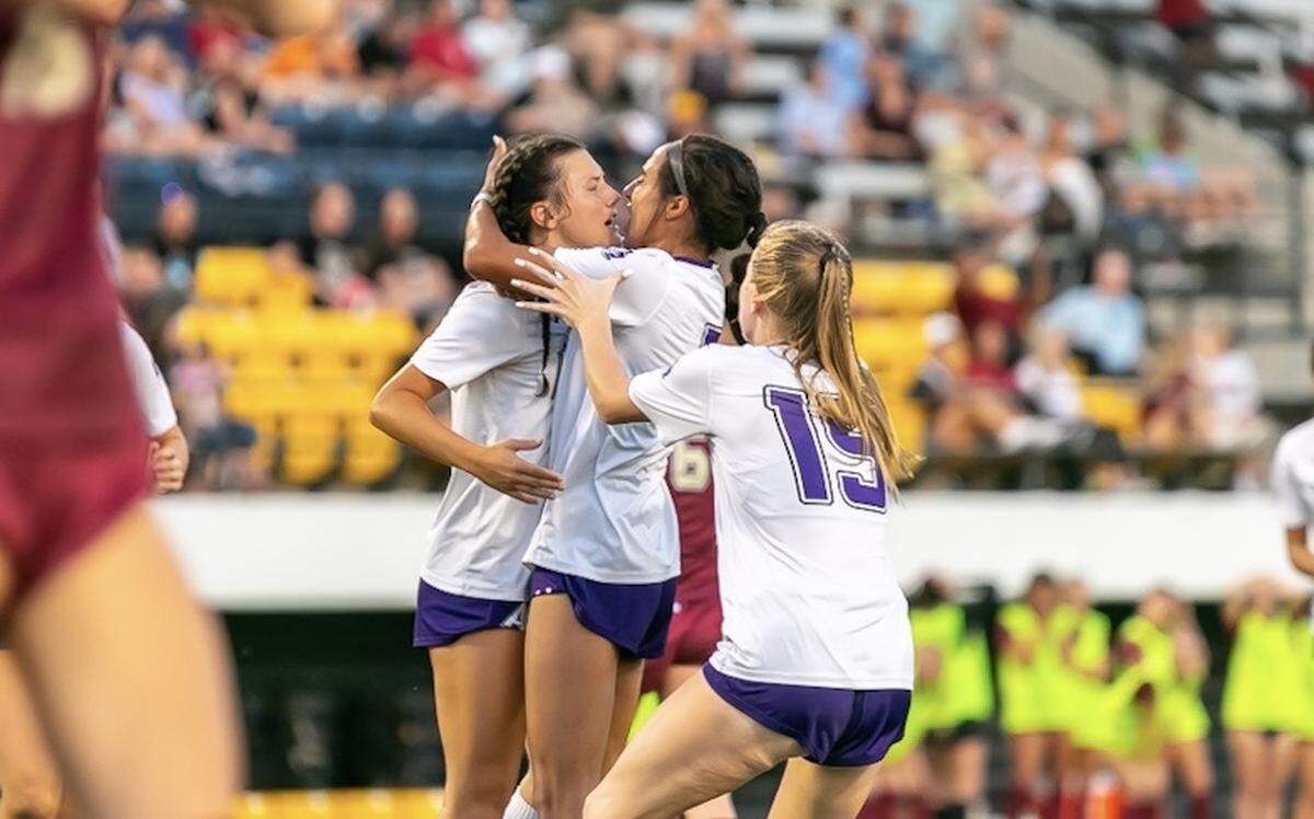 Ardrey Kell Teammates embrace after scoring their third goal giving them the lead
