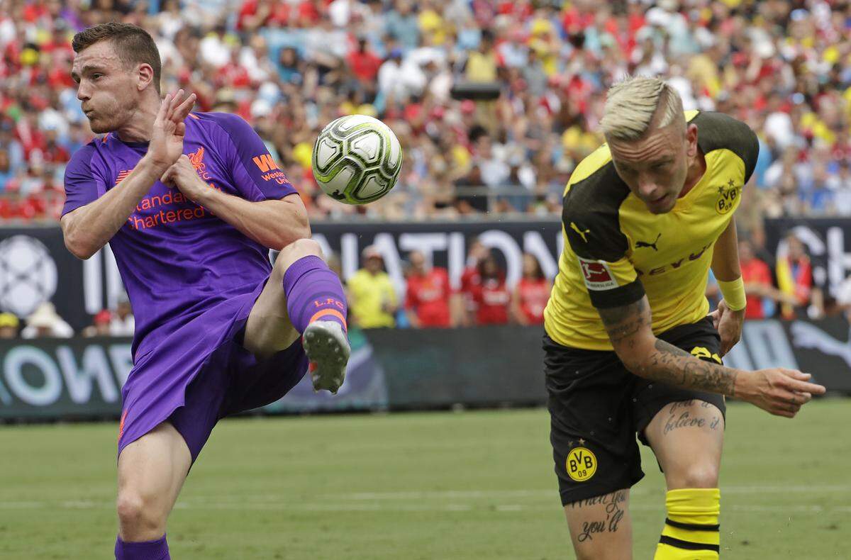 Liverpool's Andrew Robertson, left, blocks a shot by Borussia Dortmund's Marius Wolf during an International Champions Cup tournament soccer match in Charlotte, N.C., Sunday, July 22, 2018. (AP Photo/Chuck Burton)