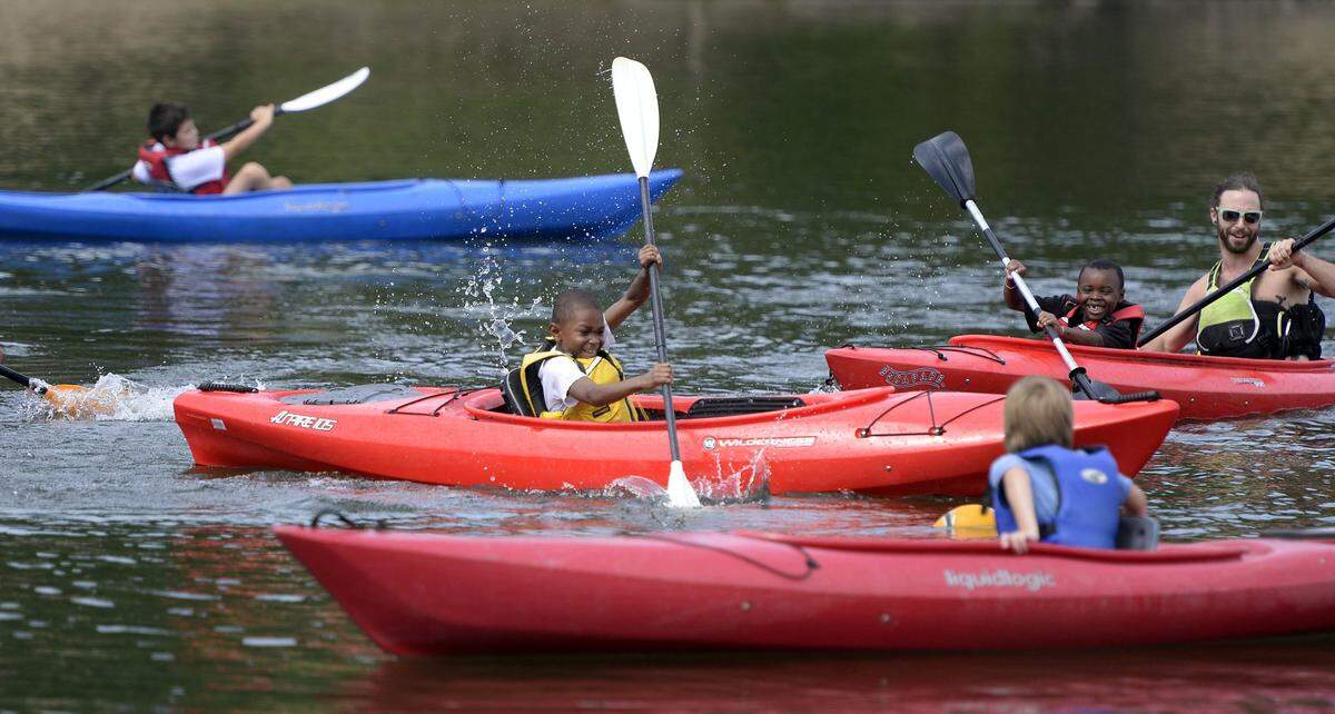 In this July 2015 photo, Jamir Easter smiles as he paddles his kayak during a session with the Urban Outdoor Connection Camp at McDowell Nature Preserve in Charlotte.