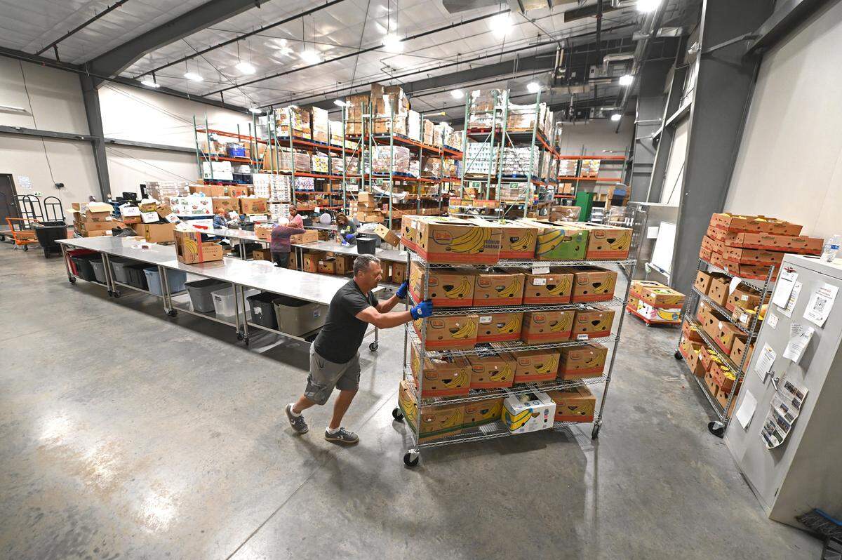 Volunteers work in the warehouse of FeedNC on Tuesday, October 24, 2023. FeedNC formerly known the Mooresville Soup Kitchen relies 100% on community donations to provide breakfast, lunch and groceries to people in need each week day. FeedNC also offers culinary and warehouse jobs. The program’s classes are 12-week programs.