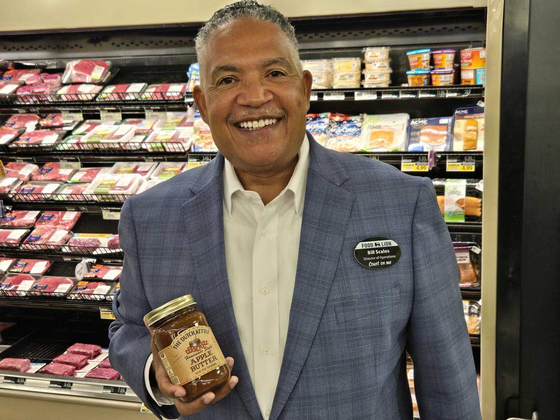 Food Lion operations director Bill Scales holds a jar of Apple Butter from The Dutch Kettle as an example of local products available from North Carolina.