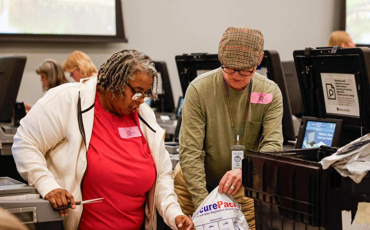 Volunteers assist Mecklenburg officials in holding a recount in the NC Supreme Court race, Tricia Cotham’s win over Nicole Sidman and Woodson Bradley’s win over Stacie McGinn, at Valerie C. Woodard Community Resource Center in Charlotte, NC on Thursday, November 21, 2024.