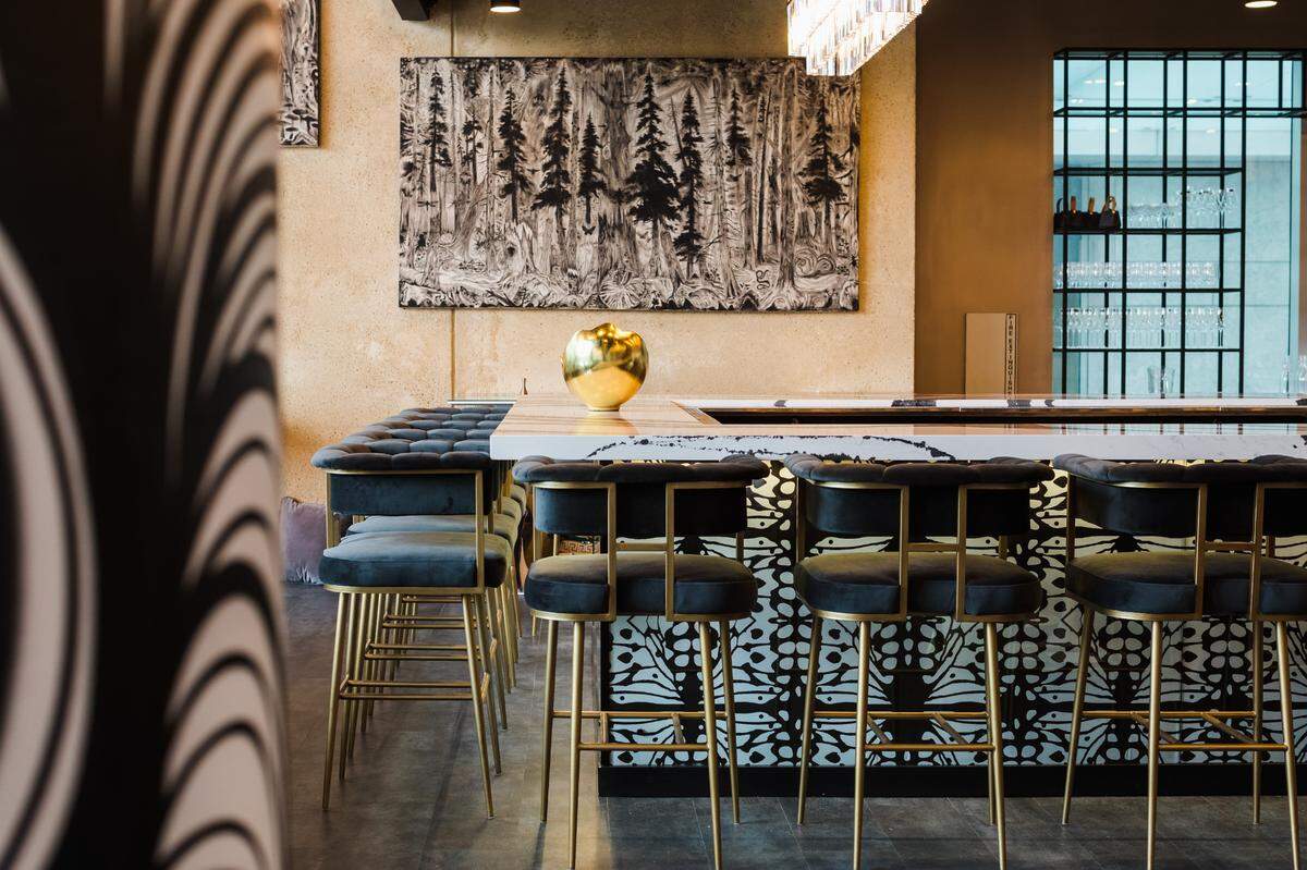 Mariposa, a new restaurant by Mother Earth Group, offers a modern and relaxing space, with black and white decor and artwork by Charlotte muralist Owl.&nbsp;
