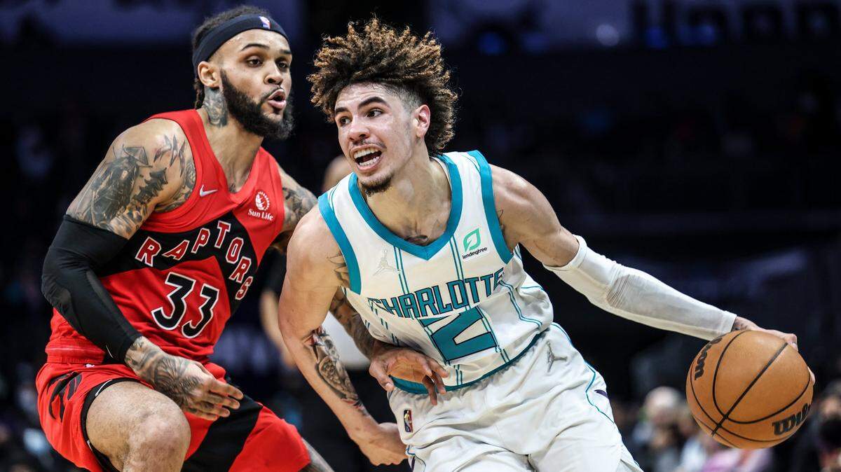 Charlotte Hornet guard LaMelo Ball, right, drives past Toronto’s Gary Trent Jr. at the Spectrum Center In Charlotte, N.C., on Monday, February 7, 2022. Toronto won, 116-101, sending the Hornets to their fifth straight loss.