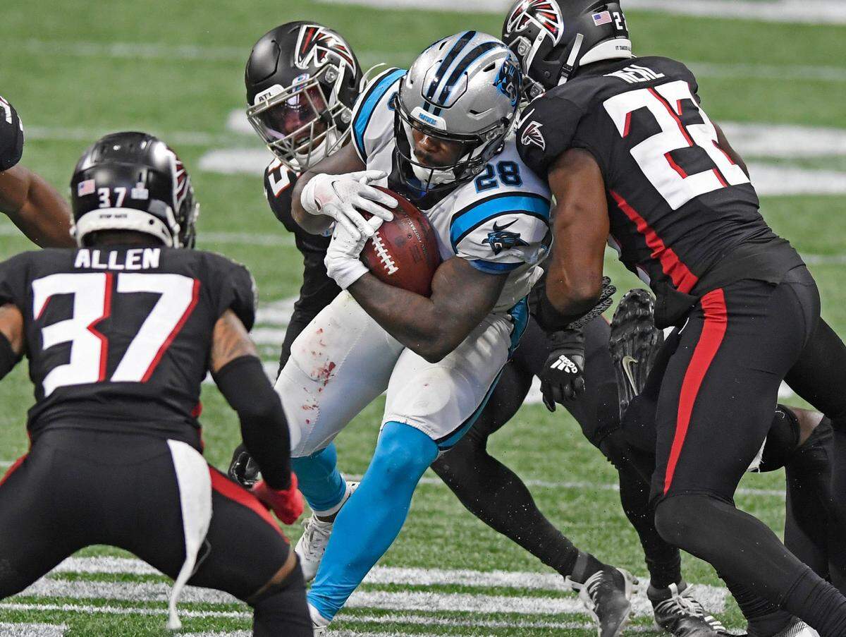 Carolina Panthers running back Mike Davis (28) powers through the Atlanta Falcons defense during the fourth quarter at Mercedes-Benz Stadium in Atlanta, GA on Sunday, October 11, 2020. The Panthers won 23-16.