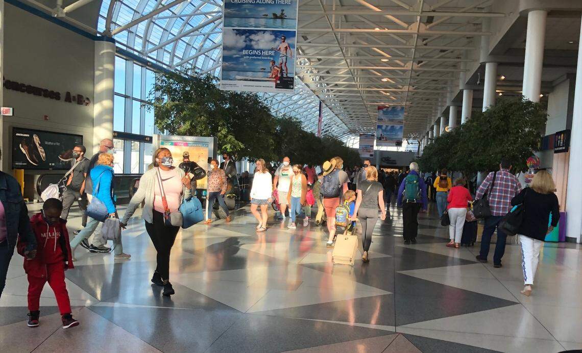 Travelers pass through Charlotte Douglas International Airport in June. The omicron variant of the coronavirus will inevitably be carried into the United States by travelers on airplanes, public health officials say.