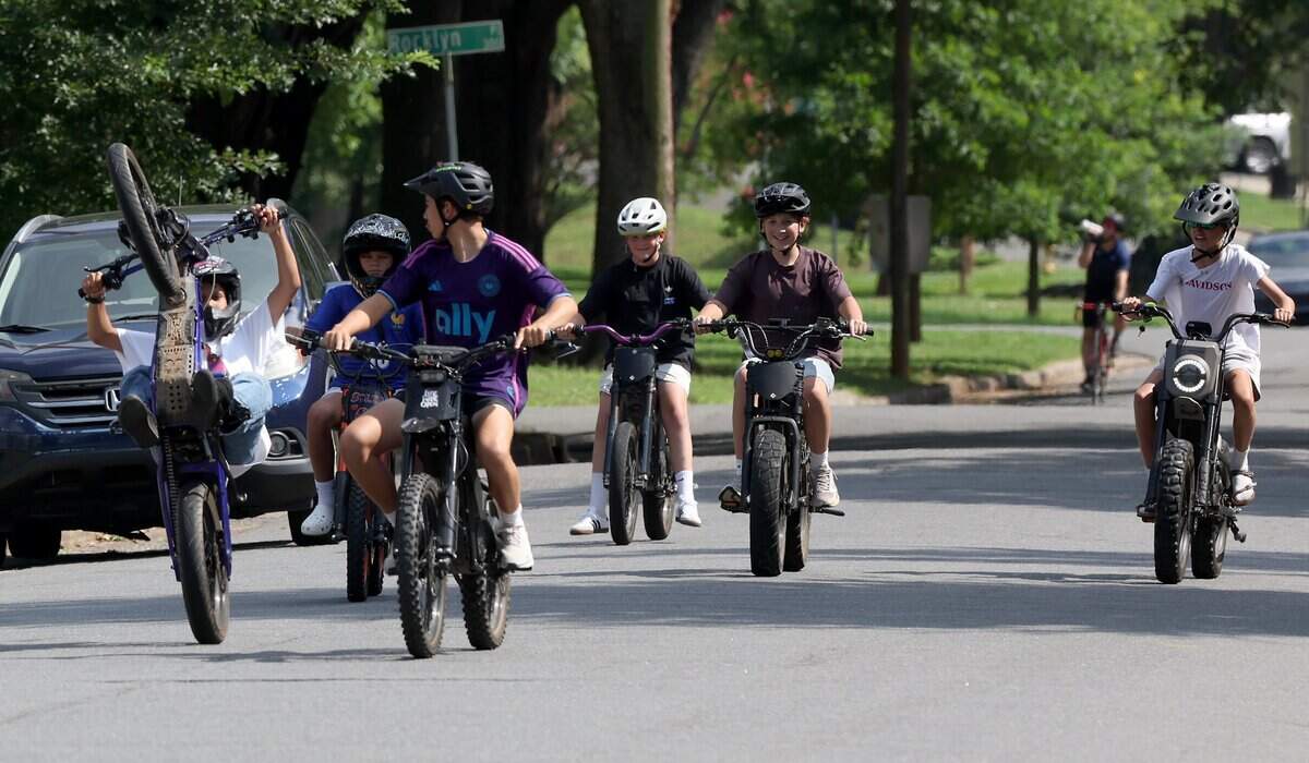 Youngsters enjoy riding their e-bikes down Westfield Road in Charlotte, NC on Tuesday, June 30, 2026.
