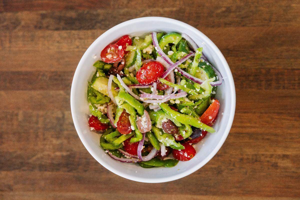The Crust Pizza includes fresh salads as part of its lineup.