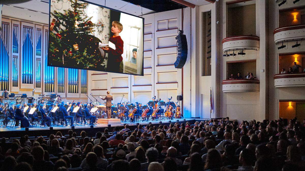 Kevin and the tree in “Home Alone” get live musical support from the Charlotte Symphony Orchestra, as “E.T.” is about to.