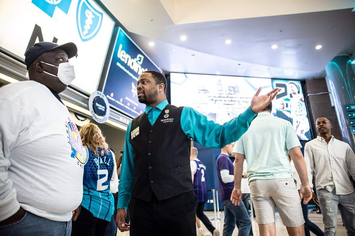 LaMichael Mitchell greets fans before a Hornets game at Spectrum Center in April.