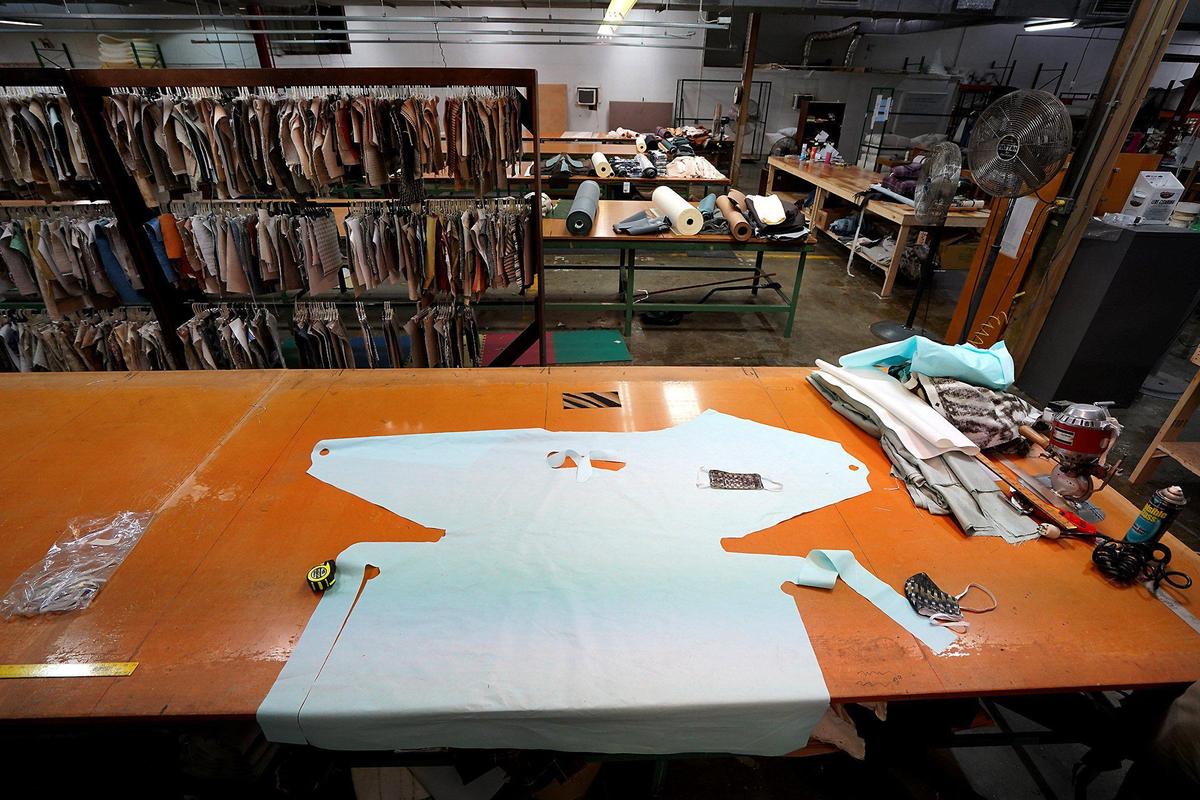 A pattern for a gown lays on a table at EJ Victor Furniture on Friday, March 27, 2020. The furniture maker has begun producing medical gowns, mask covers and a triage cot to help in the fight against the Coronavirus.