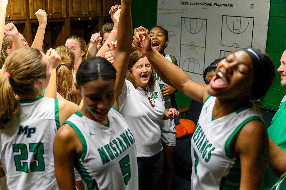 Myers Park celebrates a win over Butler Tuesday and coach Barbara Nelson’s 700th win