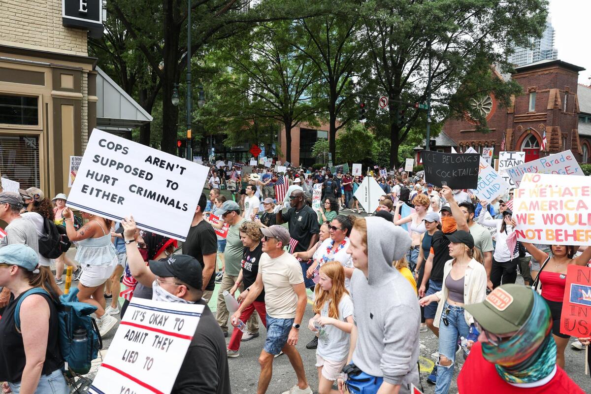 Protesters turn onto 7th Street from North Tryon Street during the No Kings protest in Charlotte Saturday, June 14, 2025.