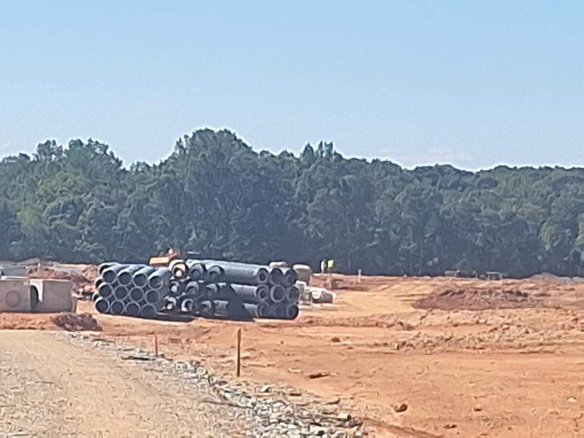 Pipes remained stacked along part of the carved-out Norman Village Road near Timber Road in Mooresville on Sept. 9, 2025.