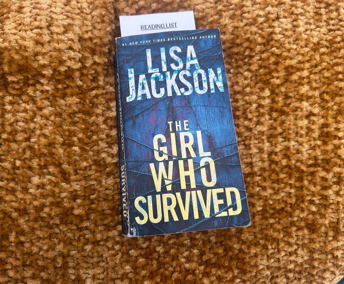 A copy of “The Girl Who Survived” by Lisa Jackson.