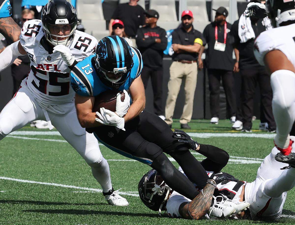 Carolina receiver Hunter Renfrow is tackled by Atlanta’s Billy Bowman Jr. on Sept. 21, 2025, at Bank of America Stadium.