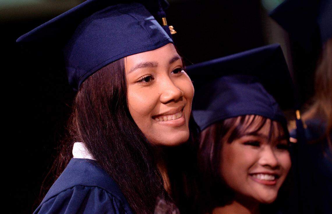 Emily Adrong, left, smiles with fellow graduate Tuet Siu, right, during graduation exercises on Friday, June 4, 2021. The Nest Academy is a tiny school that is primarily for refugee and immigrant students. Friday the school graduated three students two from this year’s class and Adrong who did not have a ceremony last year due to COVID-19.