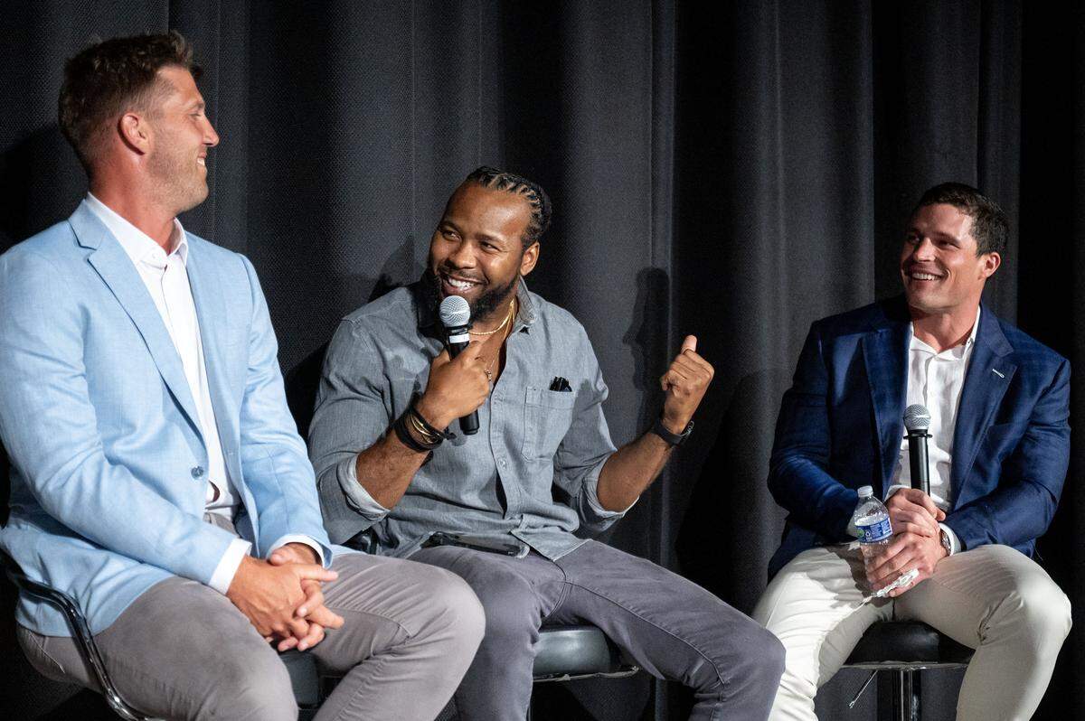 Three players from the 2015 Carolina Panthers team reminisce after the documentary premiere of “Super Men” at the Independence Picture House on July 24, 2025. From left to right: Long snapper J.J. Jansen, cornerback Josh Norman and linebacker Luke Kuechly.
