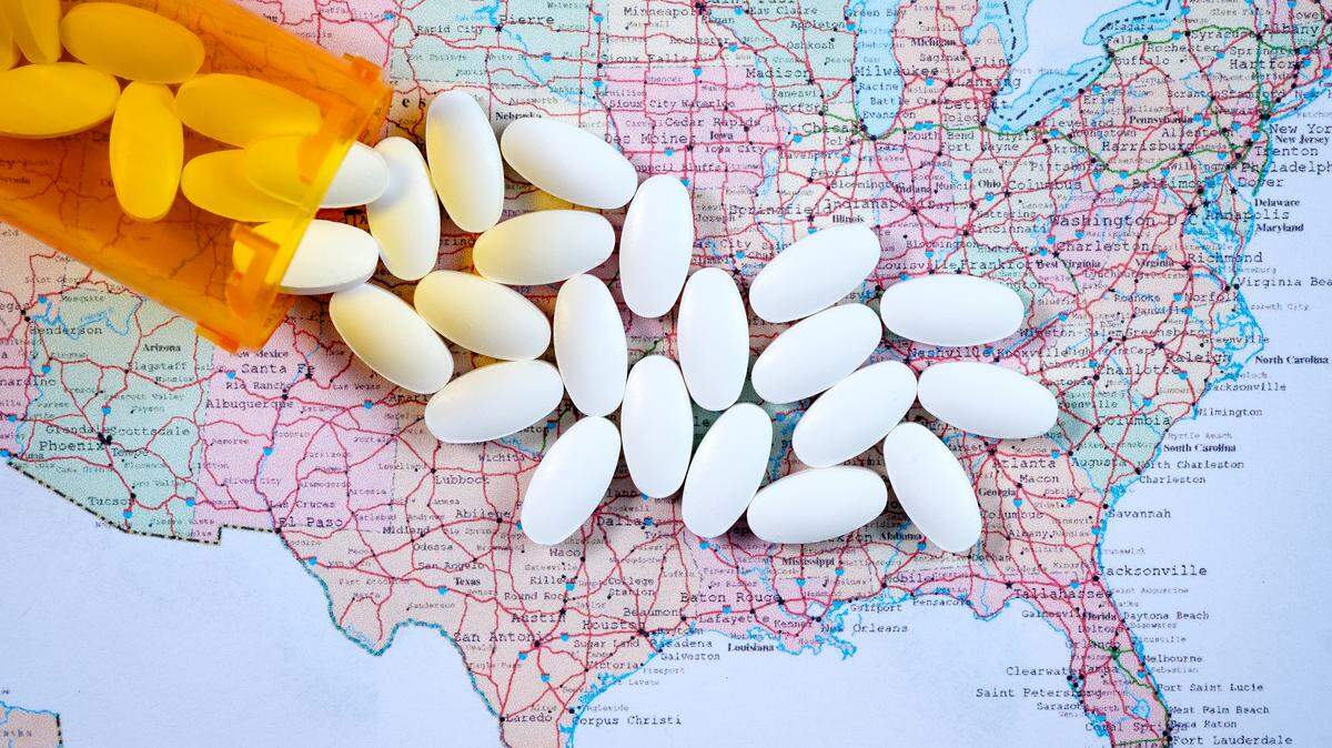 A Charlotte doctor is accused by federal prosecutors of agreeing to prescribe opioid painkillers for his patients as long as they funneled some or all of the drugs back to his wife.