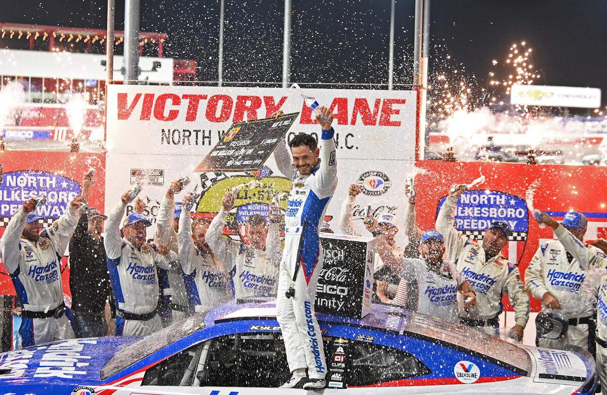 NASCAR driver Kyle Larson and his team celebrate winning the NASCAR All-Star race at North Wilkesboro Speedway on Sunday, May 21, 2023.