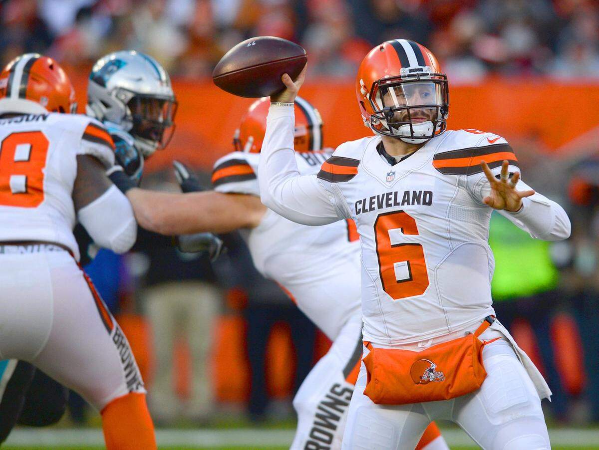 Cleveland Browns quarterback Baker Mayfield, right, drops back to pass to a receiver during third quarter action against the Carolina Panthers at FirstEnergy Stadium in Cleveland, Ohio. The Panthers lost to the Cleveland Browns 26-20 on Sunday, December 9, 2018.