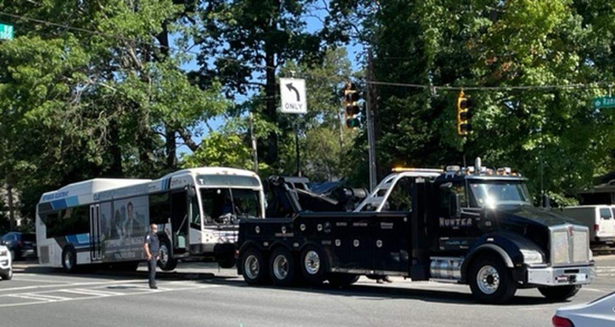 A tow truck pulls a Charlotte Area Transit System bus along Randolph Road in southeast Charlotte, NC, on Wednesday, September 21, 2022. The bus driver suffered a medical emergency, and the vehicle struck a Charlotte-Mecklenburg school bus head-on, fire officials said.