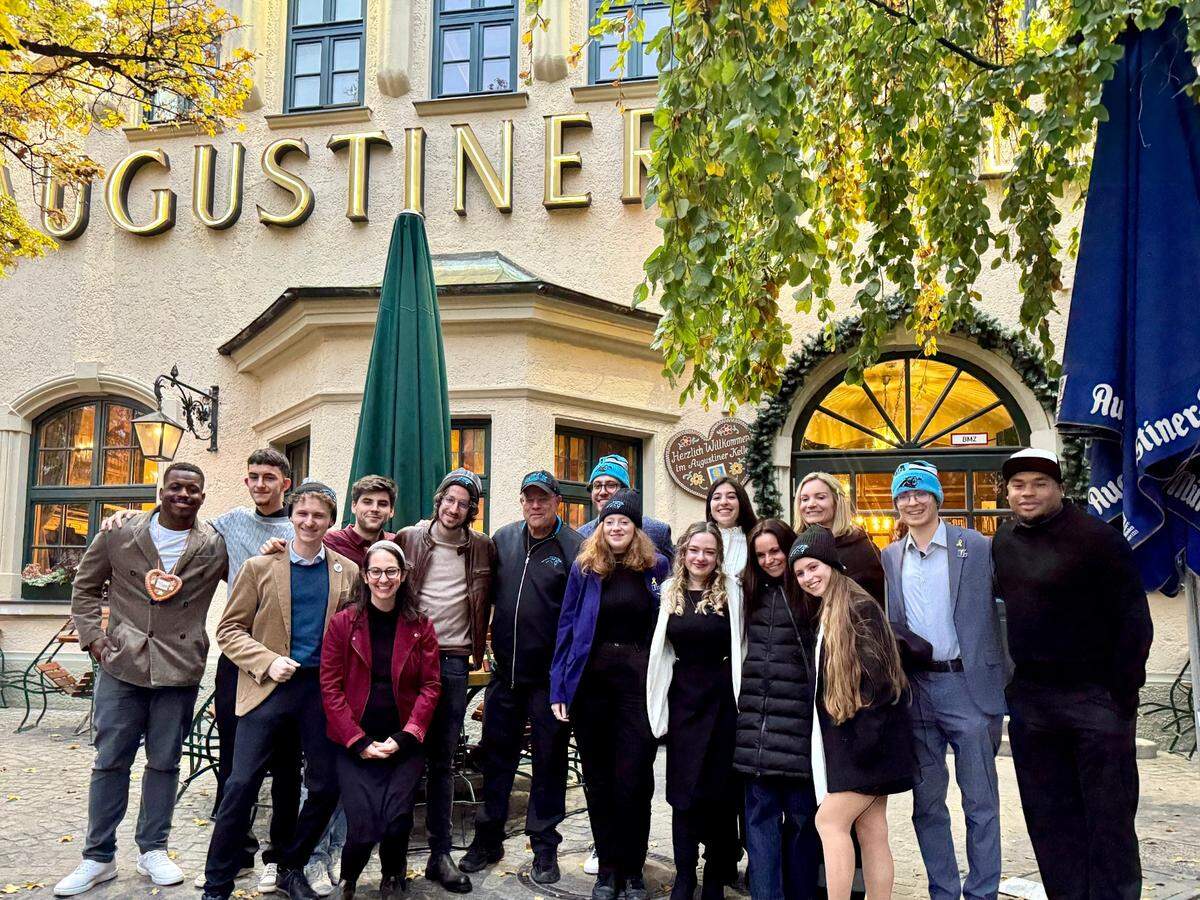 Carolina Panthers legends Jonathan Stewart (far left) and Steve Smith (far right) joined team owners David and Nicole Tepper and team president Kristi Coleman during a Jewish heritage education tour in and around Munich, Germany on Thursday. The group spoke with young German Jews to conclude the day’s events.