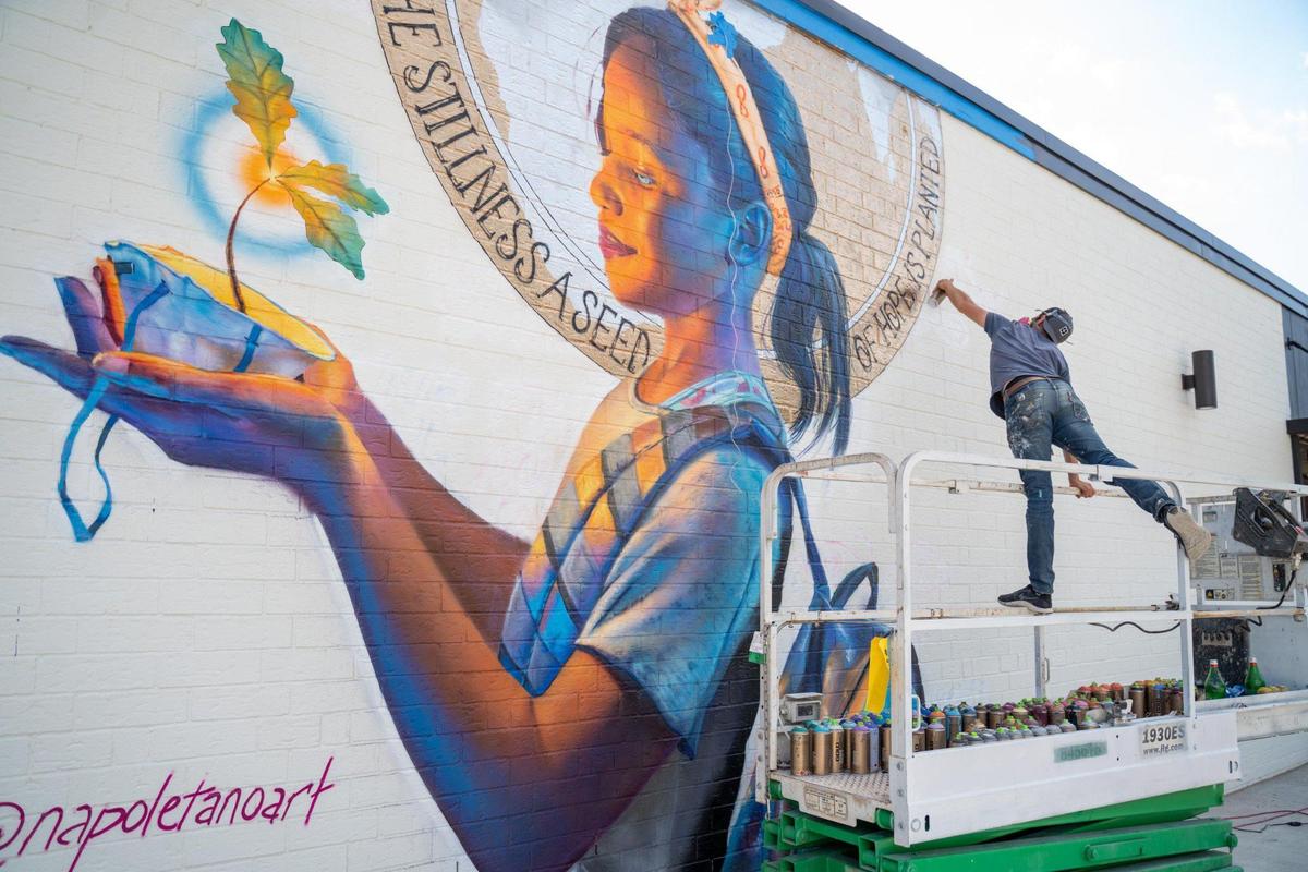 Nick Napoletano paints “From the Stillness, A Seed of Hope is Planted” at 201 Rampart Street on May 14, 2020..