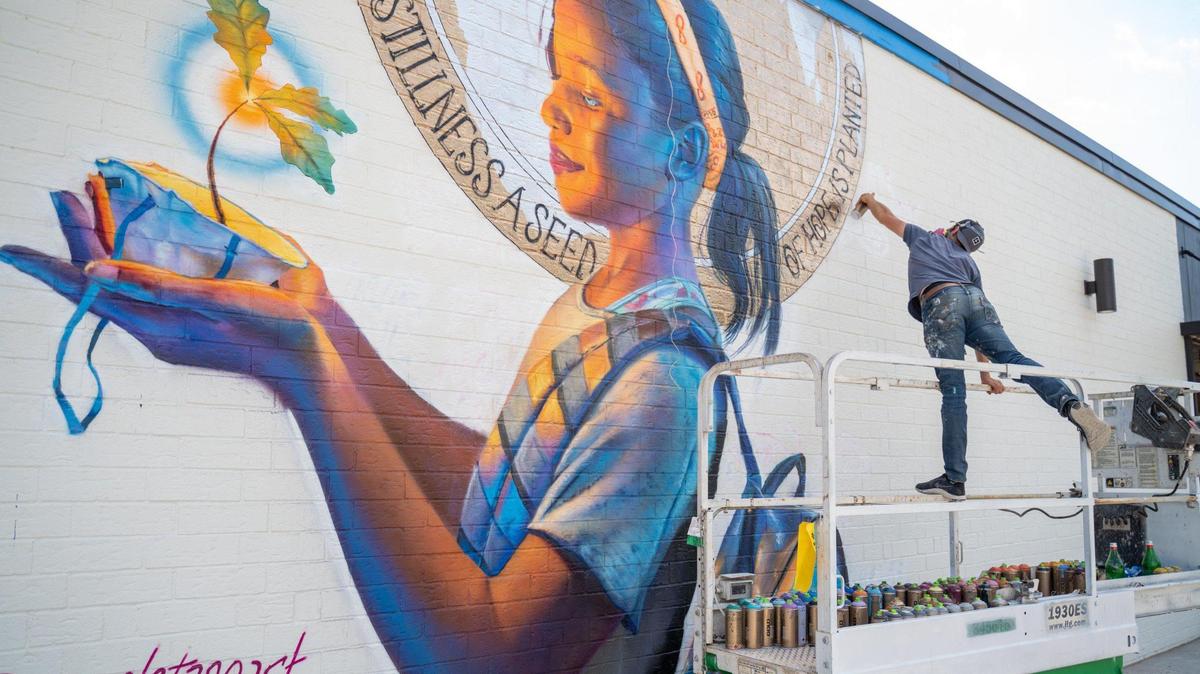 Nick Napoletano works on a mural in South End, Charlotte.