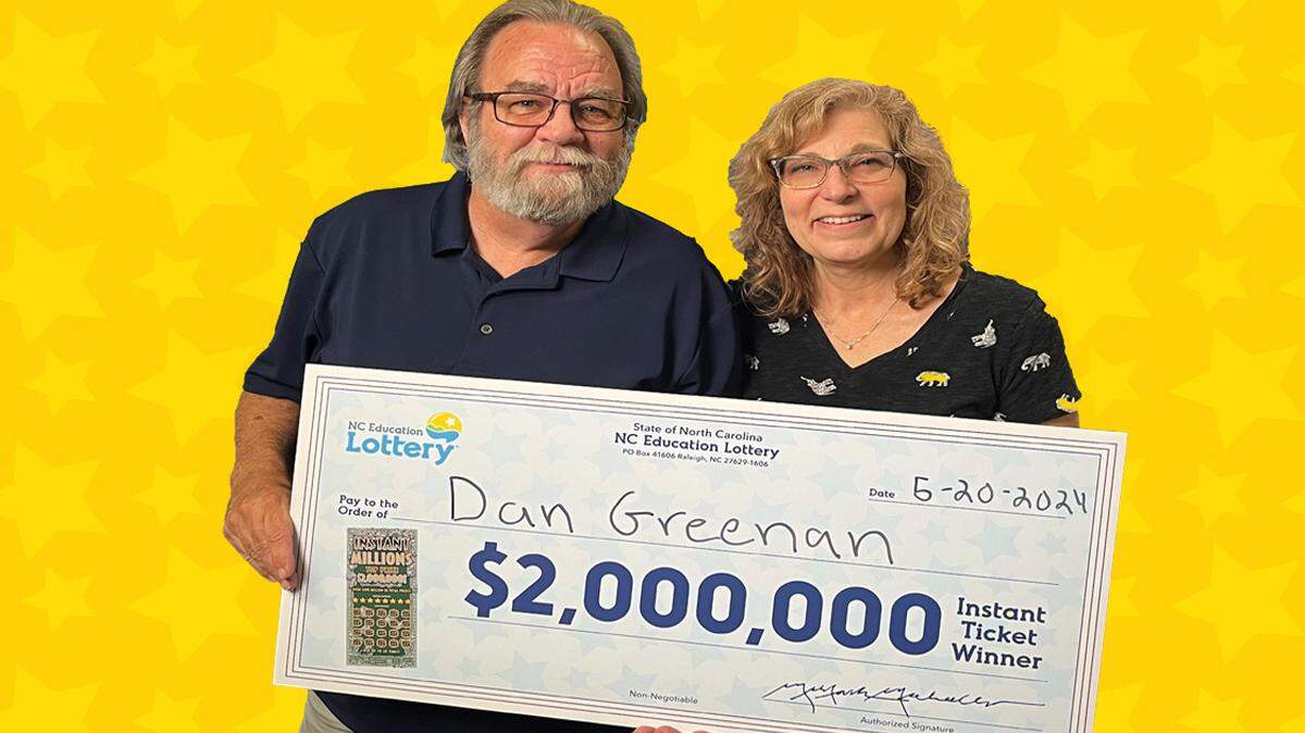 Dan Greenan poses with his partner, Lenore Connelly, at lottery headquarters in Raleigh on Monday, May 20, 2024, after his big scratch-off ticket jackpot.