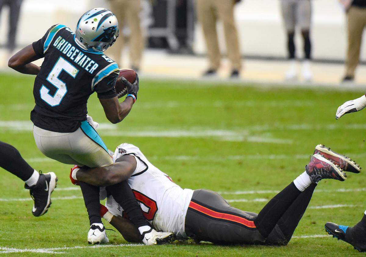 Carolina Panthers quarterback Teddy Bridgewater, left, is sacked by Tampa Bay Buccaneers outside linebacker Jason Pierre-Paul, right, during fourth quarter action at Bank of America Stadium in Charlotte, NC on Sunday, November 15, 2020.
