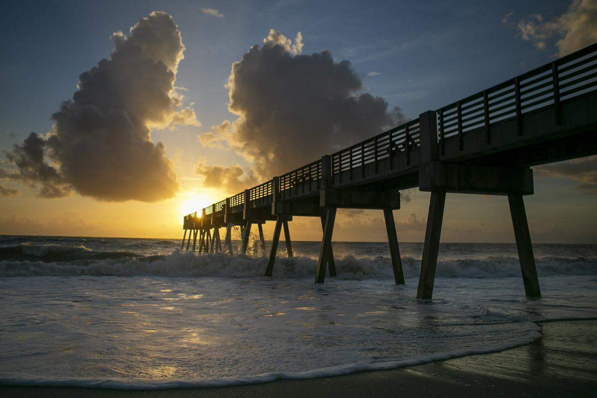 The sun rises over a private pier in Vero Beach, Florida. American Airlines is adding a direct flight from Charlotte to the Florida beach town. 